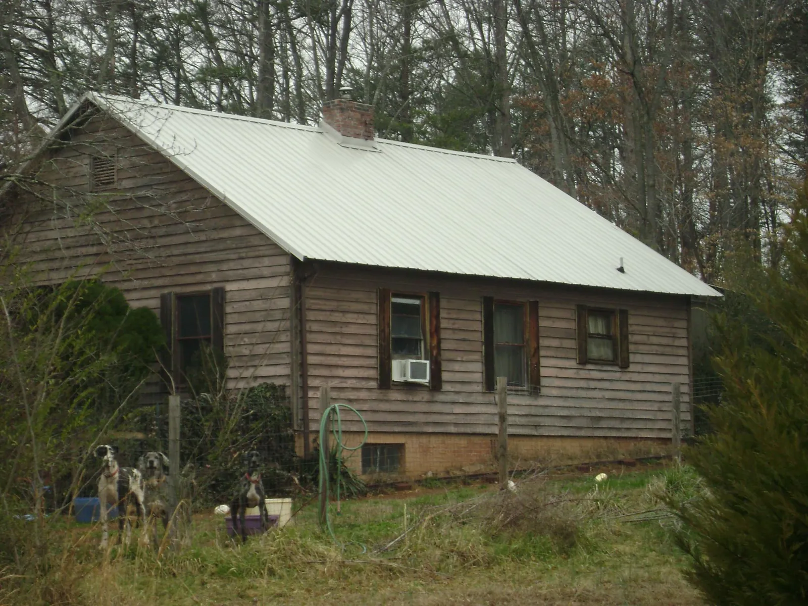 White metal roof on an old wood sided farmhouse, from a Metal Roof Installation job in South Mills